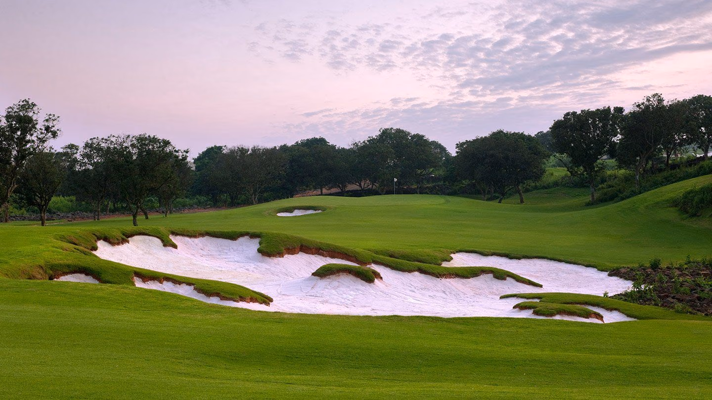 Fairways carved through black lava rock at Mission Hills Blackstone, Haikou