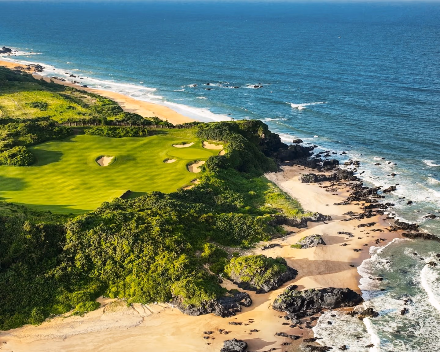 An oceanfront golf hole on Hainan's tropical coast