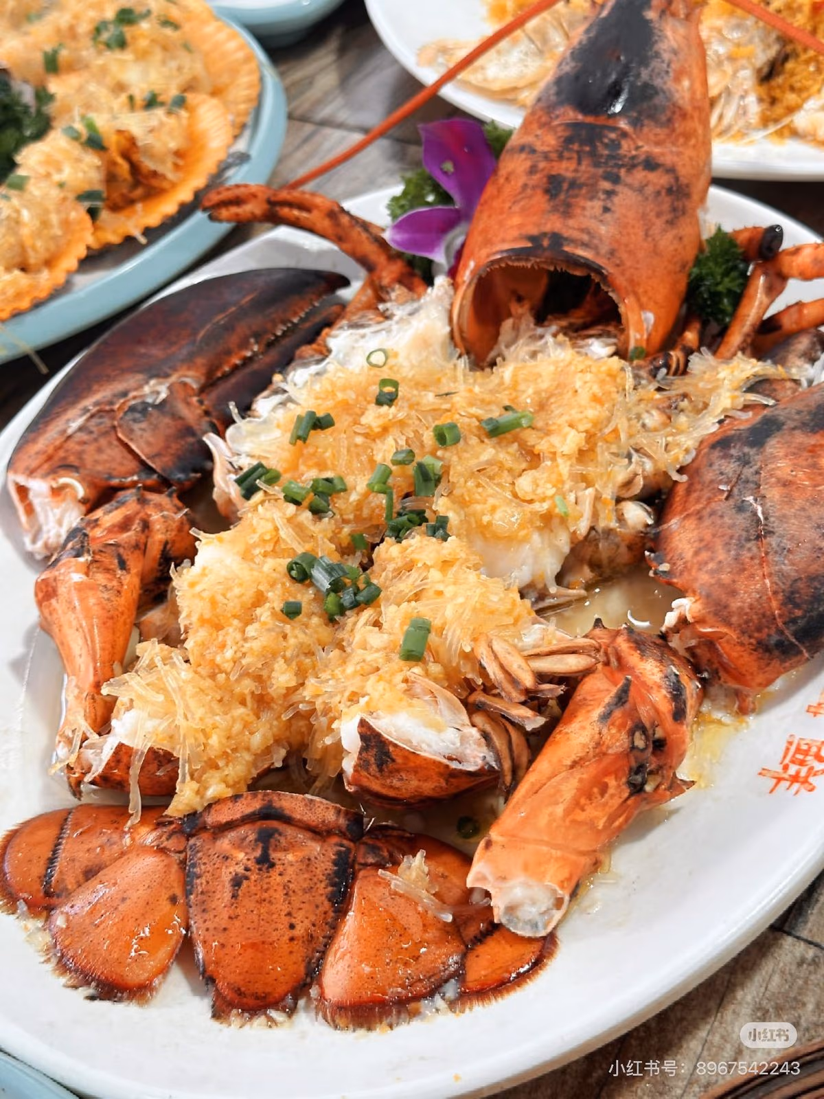A Hainanese seafood table set out by the water at dusk