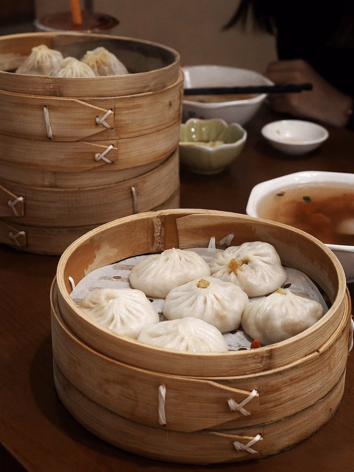 Bamboo steamers of xiaolongbao soup dumplings on a Shanghai table