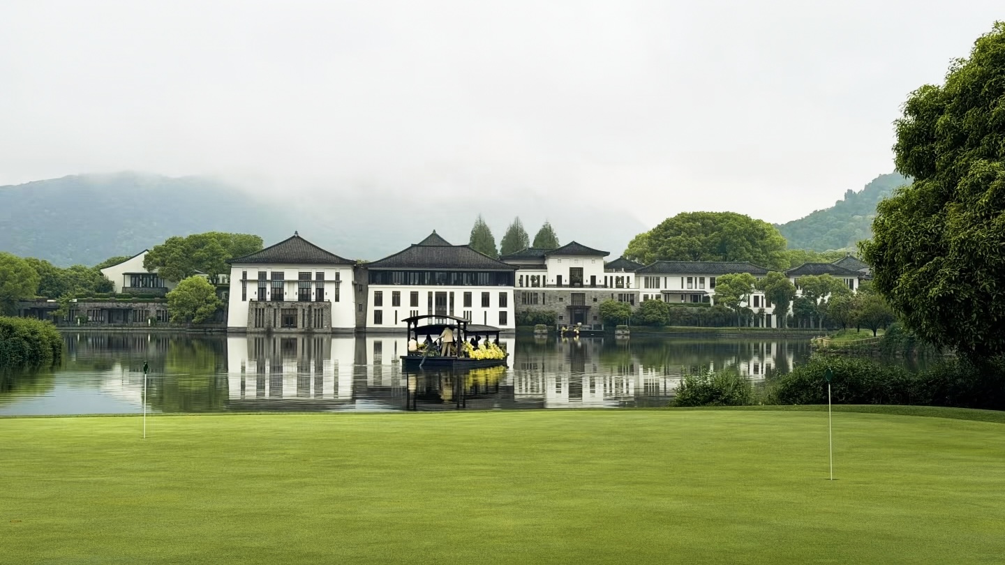 Fuchun Resort fairways and a Jiangnan-style resort mirrored in still water, Hangzhou