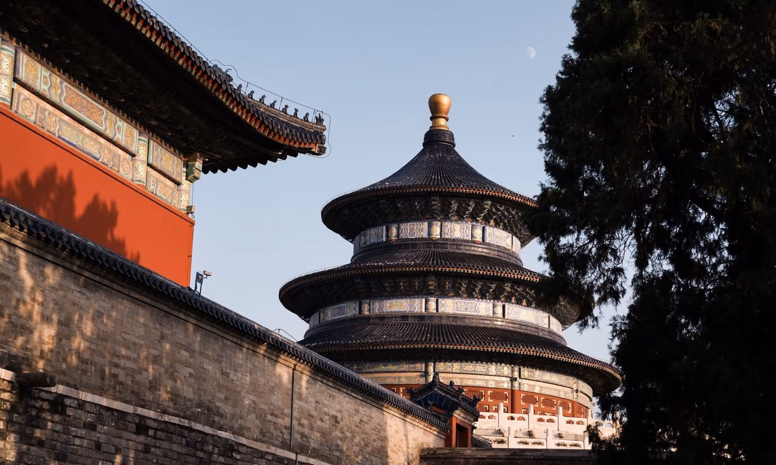 The Temple of Heaven glowing at golden hour beside imperial walls, Beijing