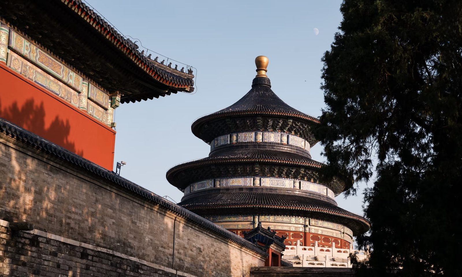 The Temple of Heaven glowing at golden hour beside imperial walls, Beijing