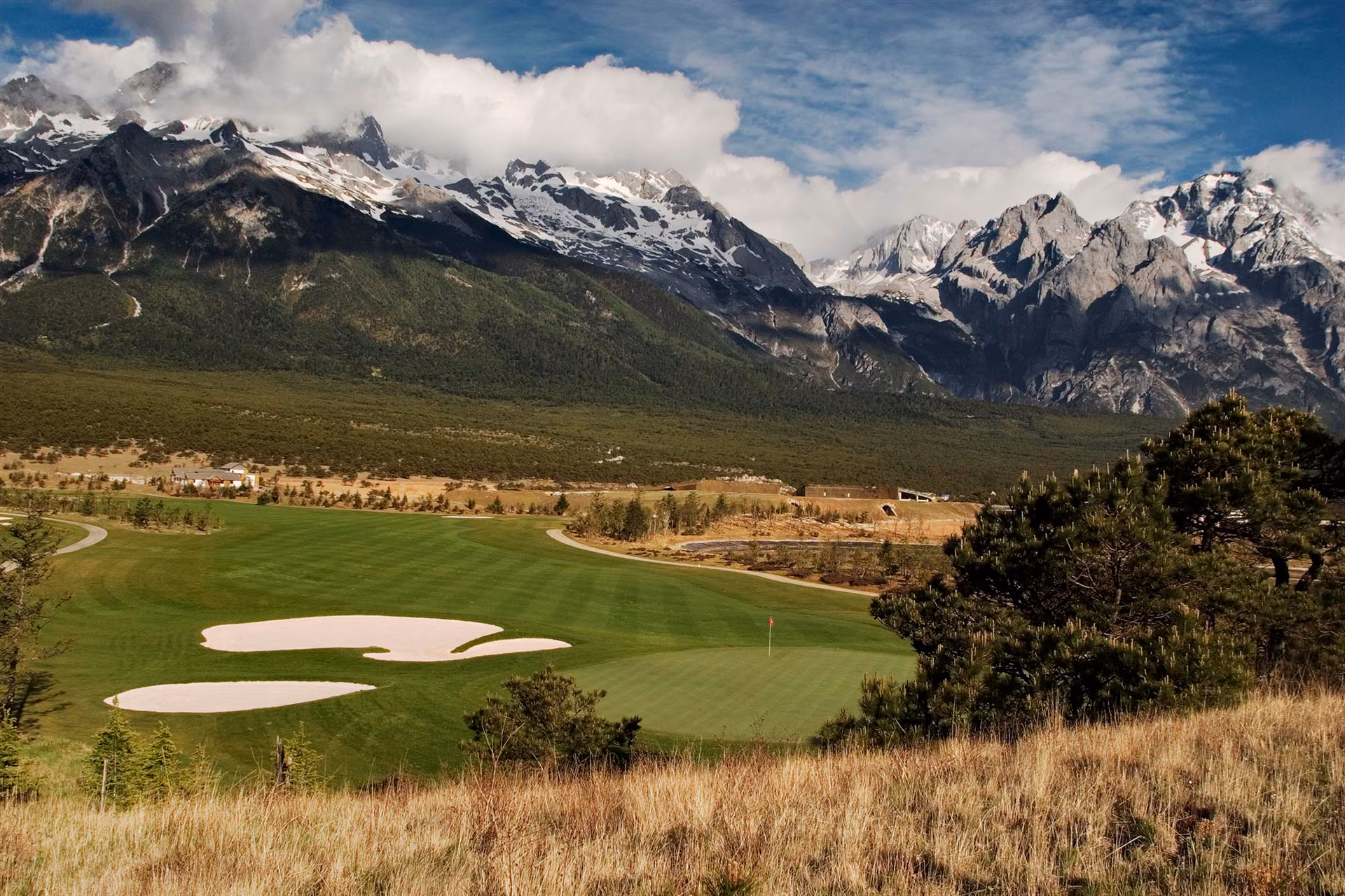 A fairway beneath the snow peaks of Jade Dragon Snow Mountain, Yunnan