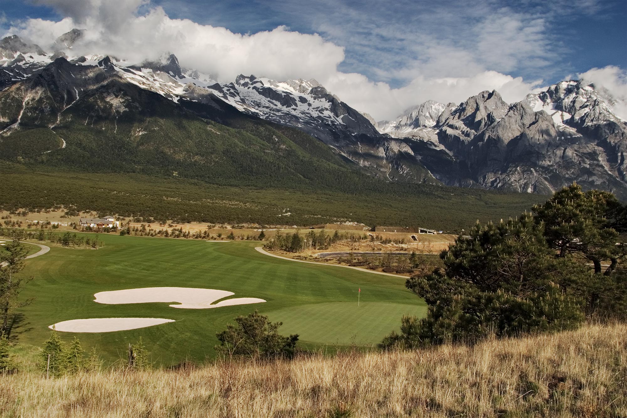 A fairway beneath the snow peaks of Jade Dragon Snow Mountain, Yunnan