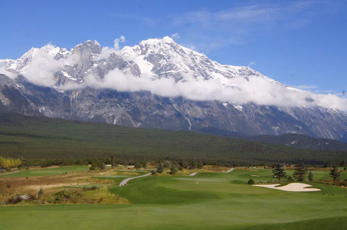 A fairway running beneath the snow peaks of Jade Dragon Snow Mountain, Lijiang