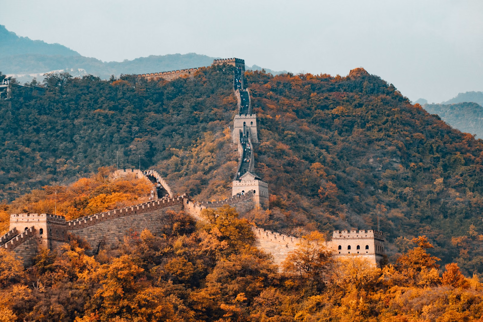 The Great Wall snaking over ridgelines at golden hour