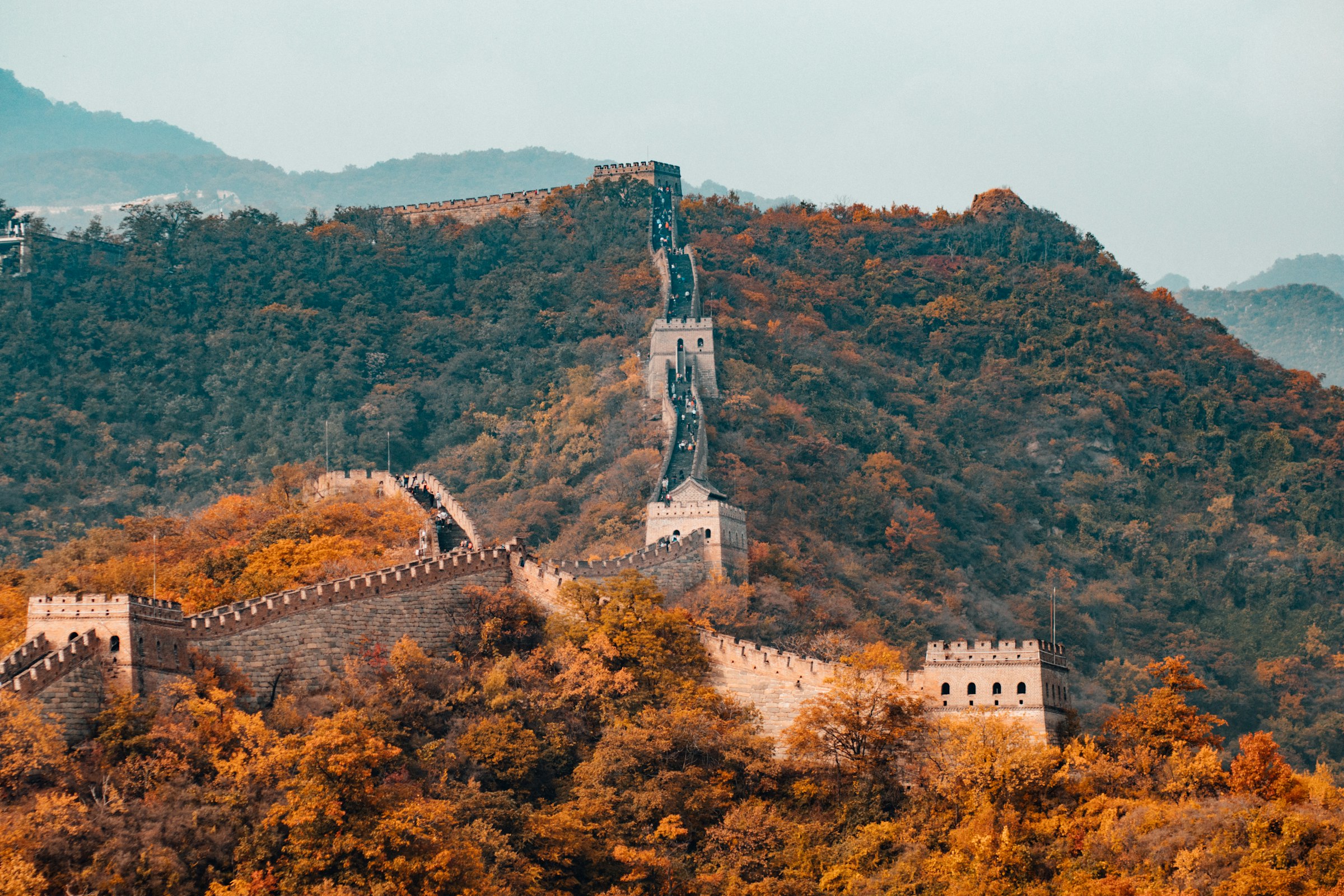 The Great Wall snaking over ridgelines at golden hour, north of Beijing