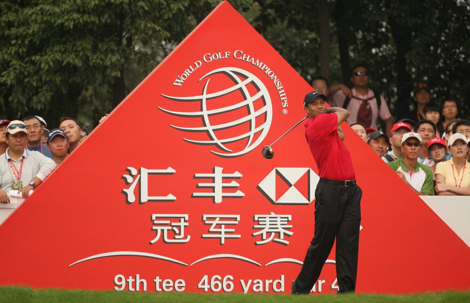 A drive launched past the red world-championship sign on the 9th tee at Sheshan