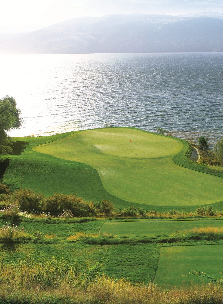A green of the Lake Course jutting toward the silver water of Yangzong Lake