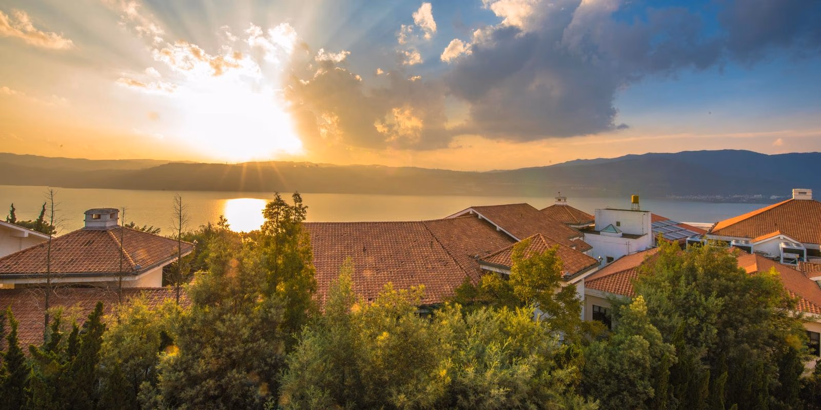 Spring City resort glowing at dusk above Yangzong Lake