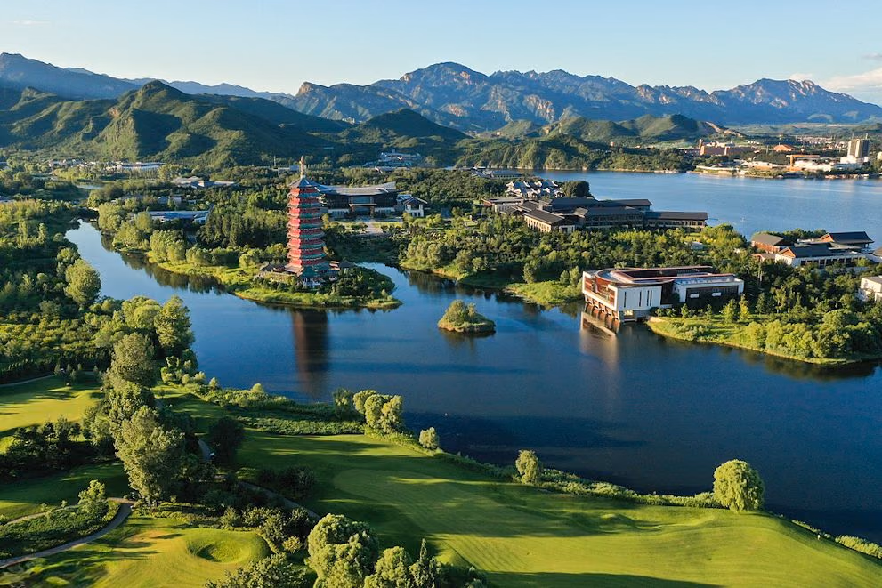 Aerial view of Topwin's fairways along Yanqi Lake, with the lakeside pagoda and the Yanshan mountains beyond, Beijing