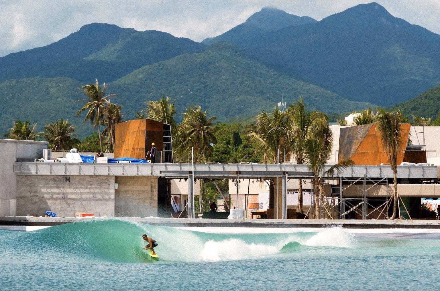 A surfer riding a clean, peeling wave at a PerfectSwell wave pool on Hainan's surf coast