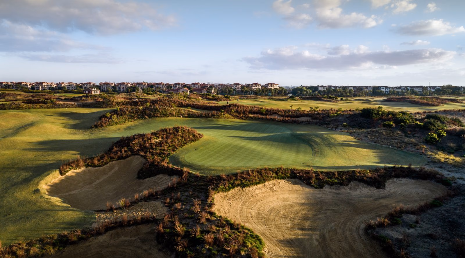 Aerial view of a green among the dunes at Yangtze Dunes